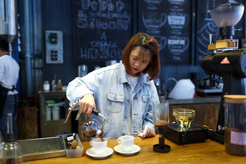 Woman Pouring Coffee on Cup