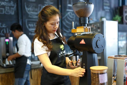 コーヒー豆を挽く女性