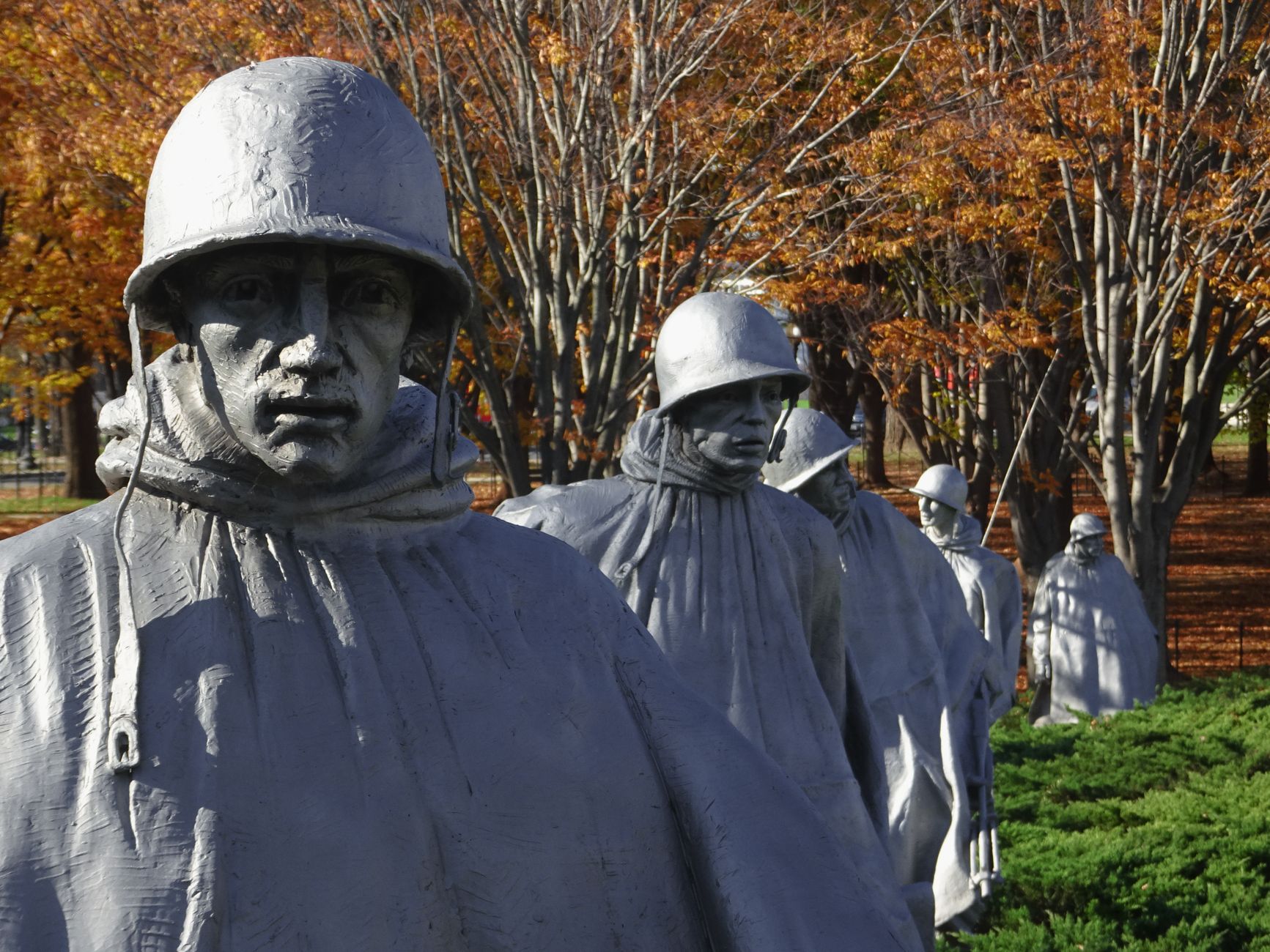 Statues of soldiers at the Korean War Veterans Memorial in autumn.