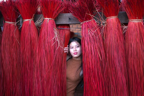 Woman in Brown Tank Top on Red Straw