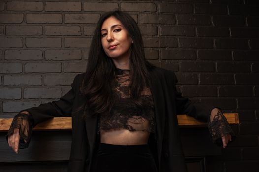 Portrait of a Female Model Wearing a Black Jacket with Lace Cuffs