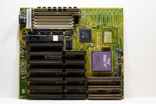 Close-up of a vintage motherboard showcasing Intel microprocessor and slots for hardware integration.