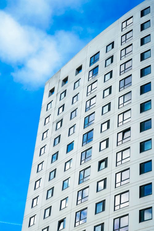 A tall building with windows and a blue sky