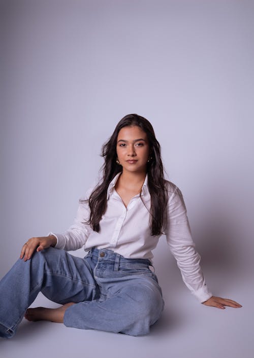 Brunette Posing in White Blouse and Jeans