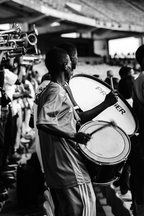 Free A captivating black and white image of a drummer performing live on stage with a band. Stock Photo