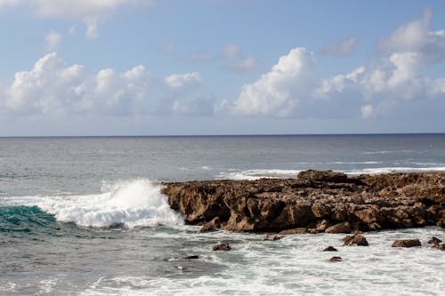 A rocky shoreline with waves crashing into the ocean