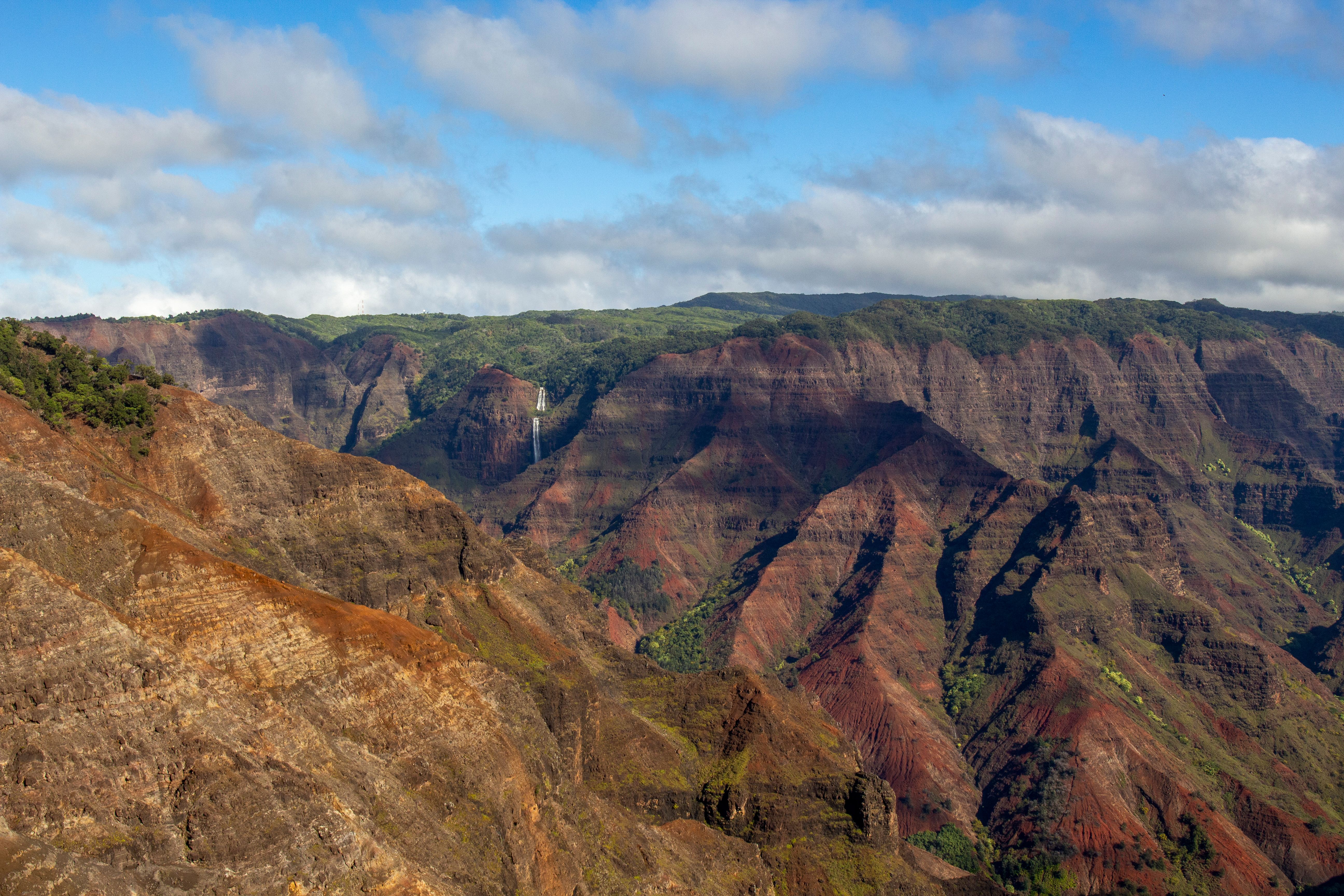Kauai Private Helicopter Ultimate Waterfall & Canyon, Free Video - Explore the vibrant geology and breathtaking vistas of Waimea Canyon in Kauai, Hawaii, captured in stunning detail.