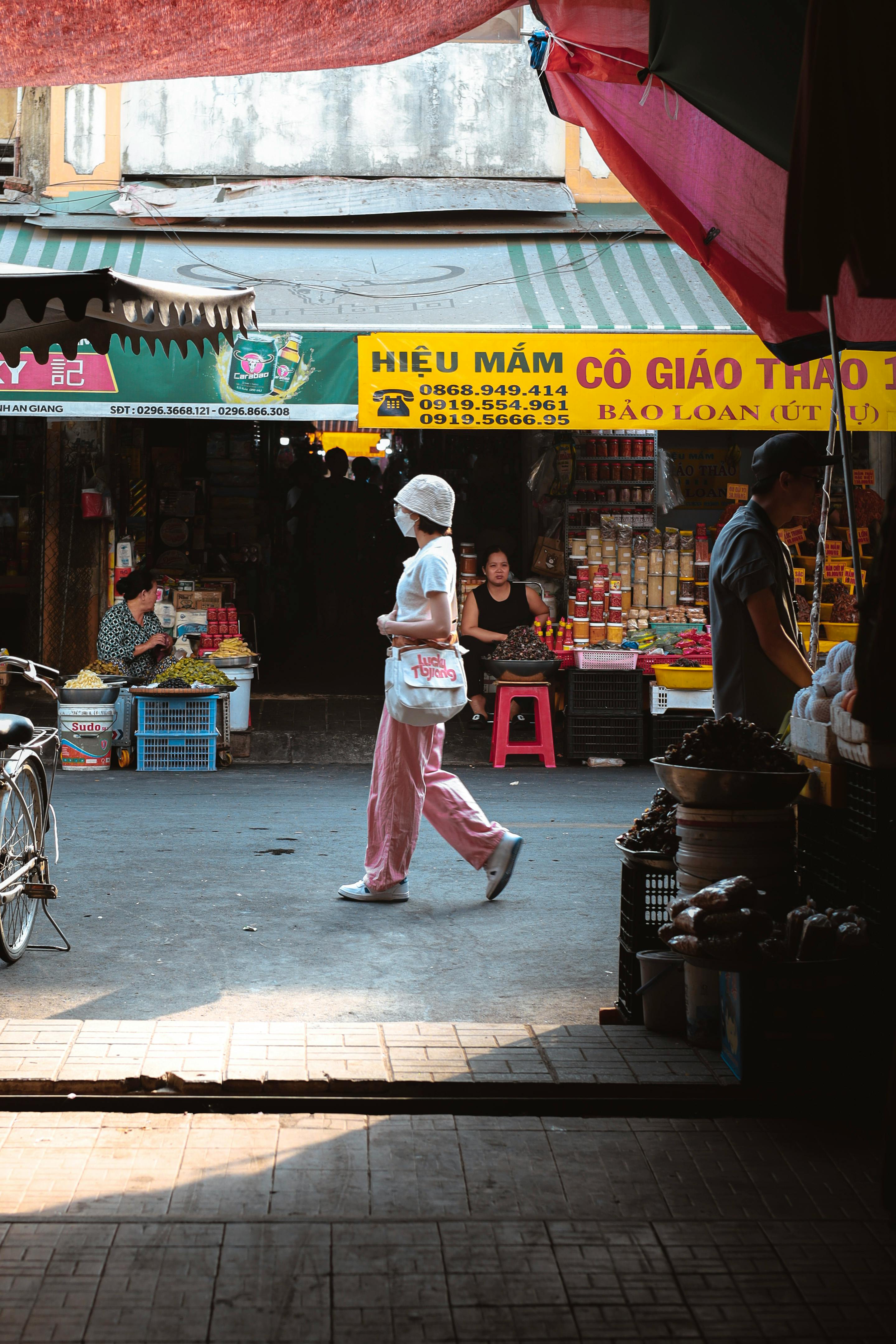 Explore the vibrant streets of Châu Đốc at a local market bustling with activity.
