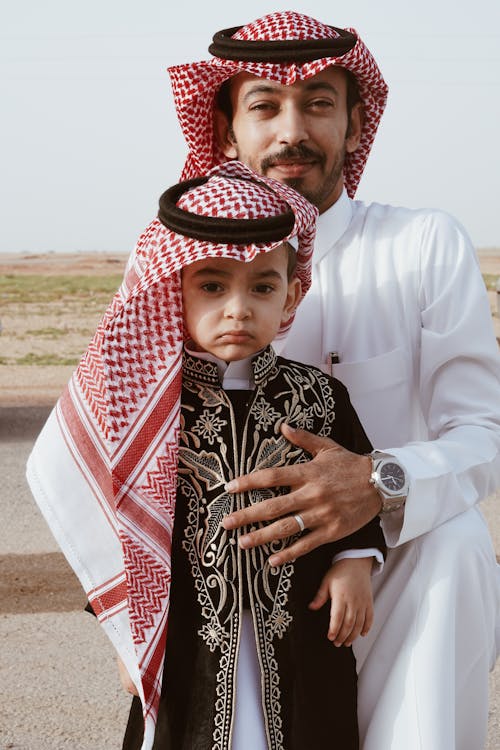 Free A man and a child in traditional arab clothing Stock Photo