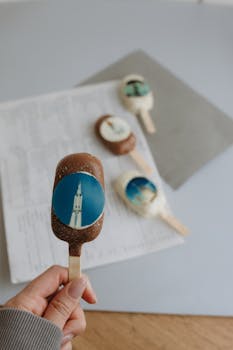 Chocolate and vanilla ice creams with artistic designs laid on paper background, perfect for creative dessert ideas.
