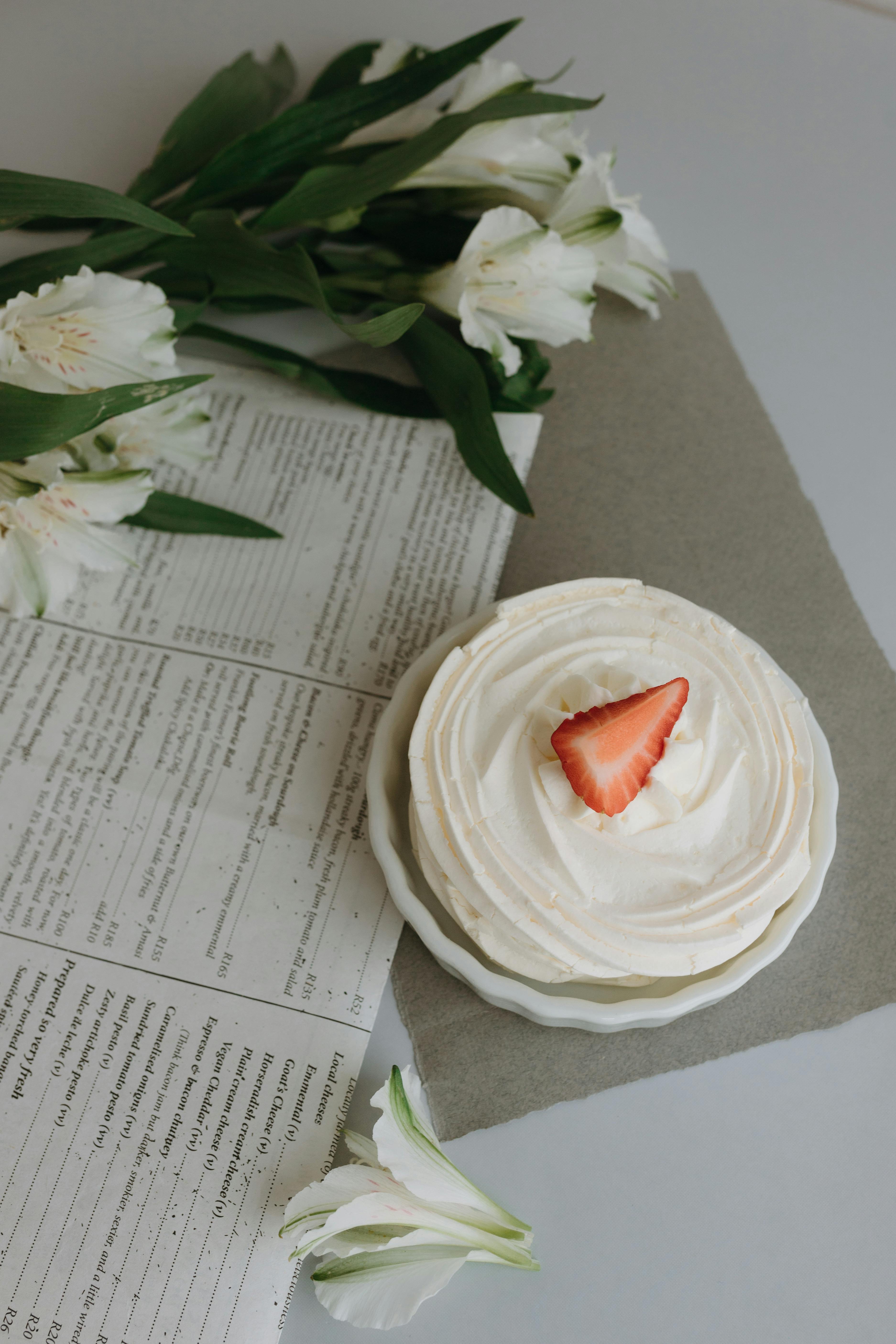 meringue cake and roses on a table