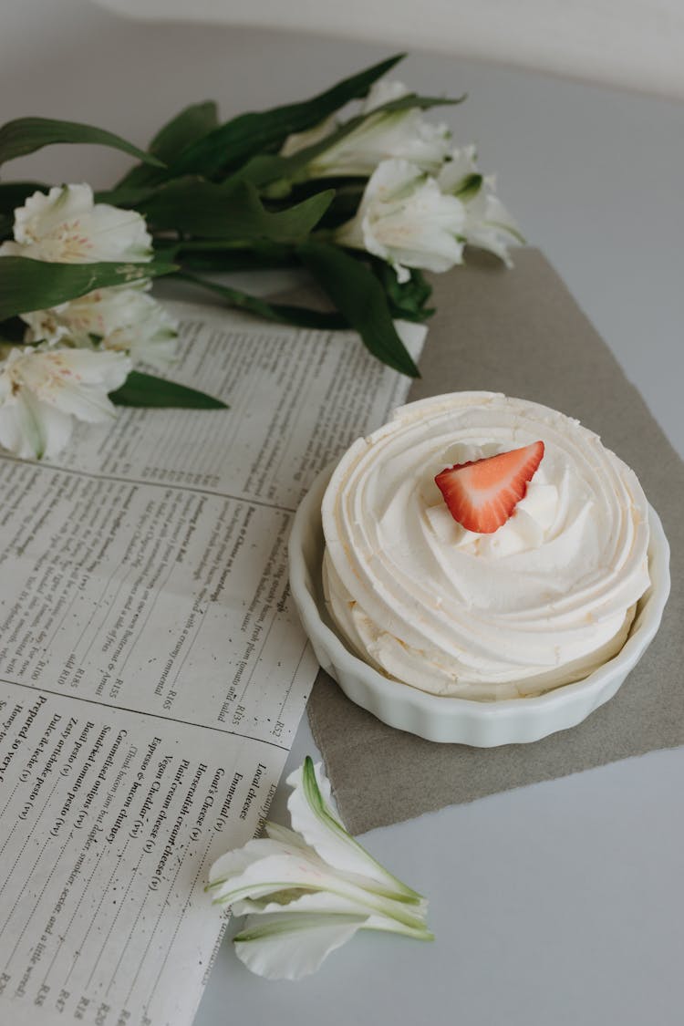 Meringue Cake And Roses On A Table