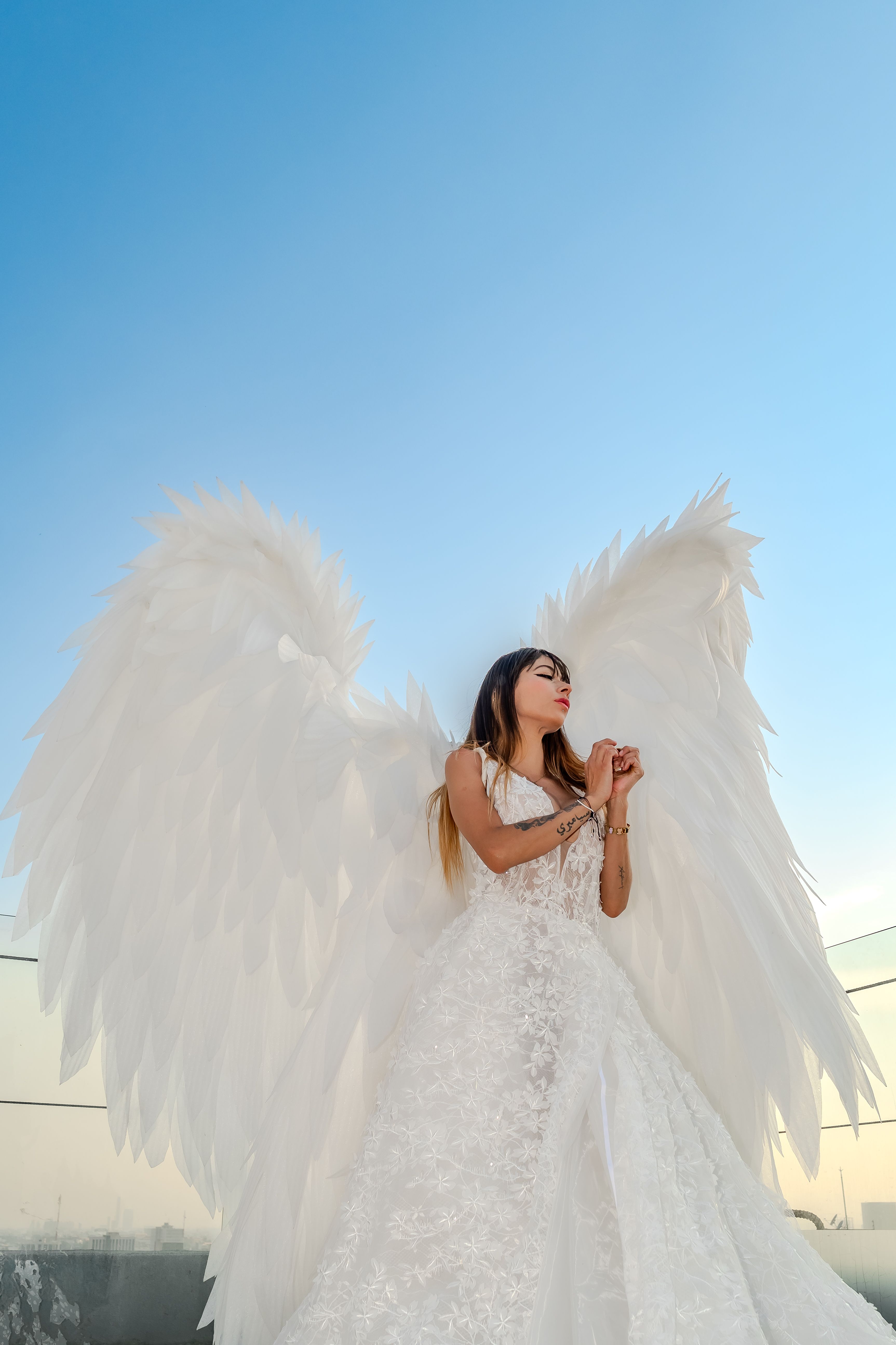 Bride Standing in Wedding Dress with Angel Wings  Free Stock Photo