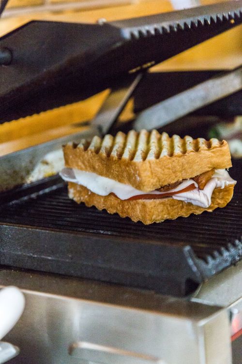 Free A delicious grilled cheese sandwich being cooked on a panini press. Stock Photo