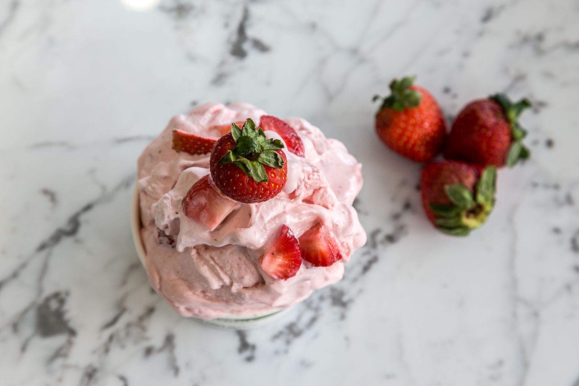 Fresh strawberries sliced for ice cream preparation