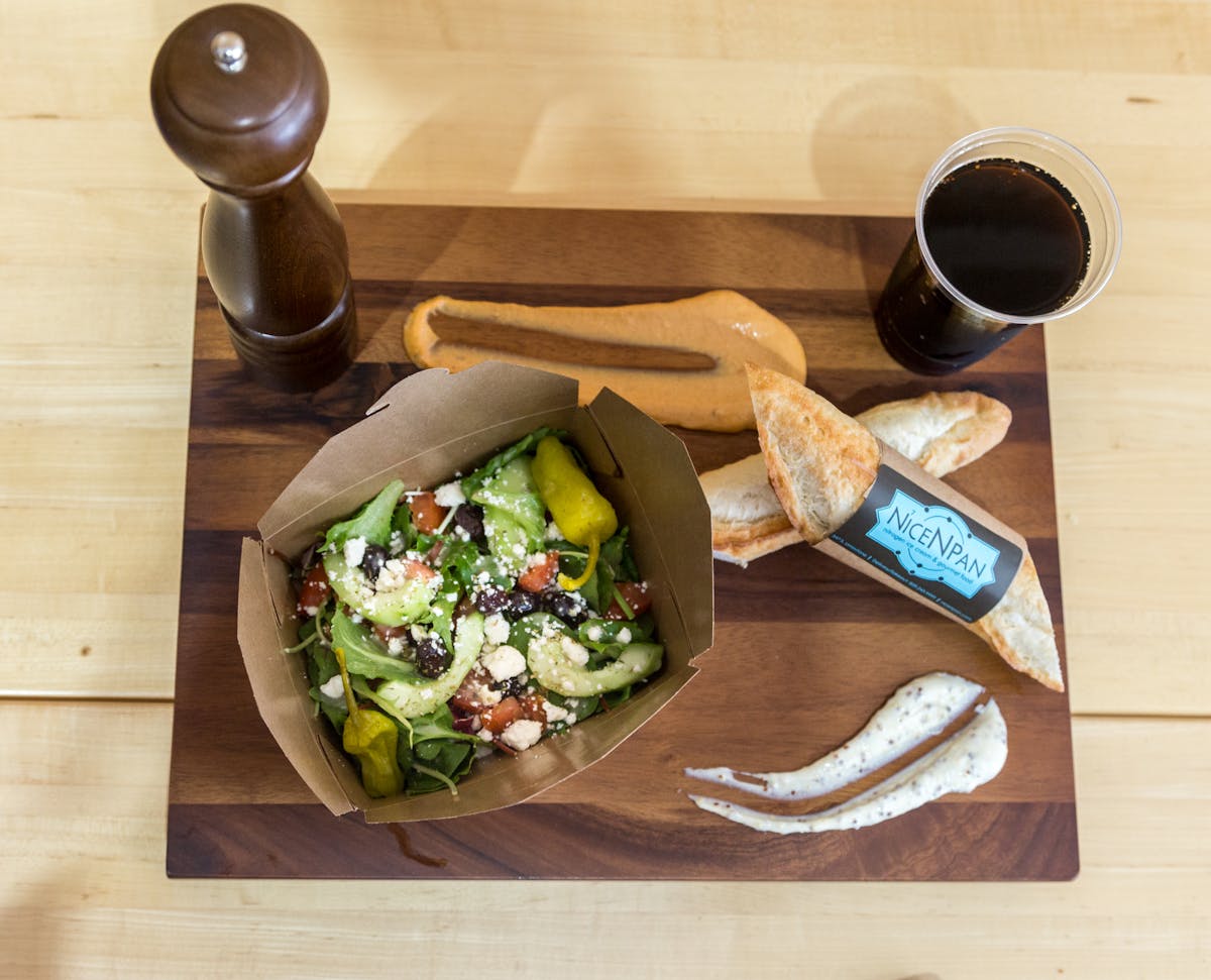 Creamy tahini sauce being whisked in a small bowl