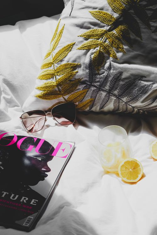 Free Fashionable bedside setup featuring Vogue magazine, sunglasses, and lemon slices in Paris. Stock Photo