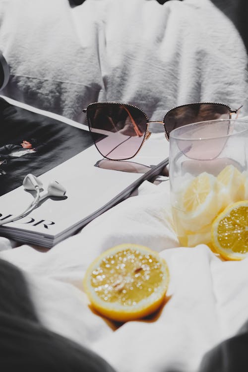 Free A person laying in bed with a book and lemon slices Stock Photo