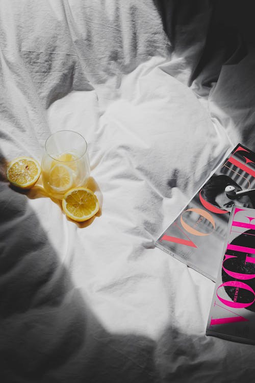 Free A magazine and a glass of lemonade on a bed Stock Photo