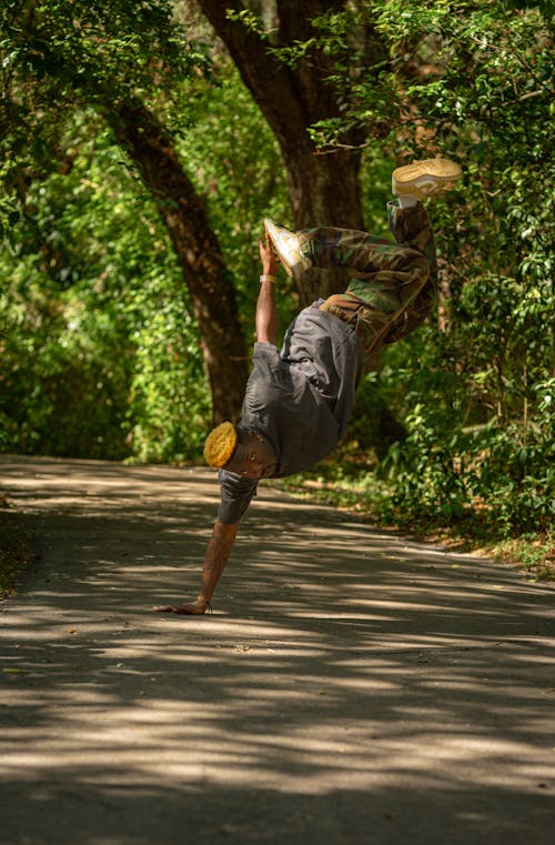 A man doing a handstand on a road