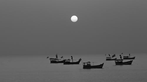 Boats in the sea during sunset