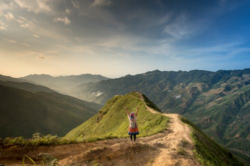 Free Photo of Woman Standing On Top Of Mountain Stock Photo