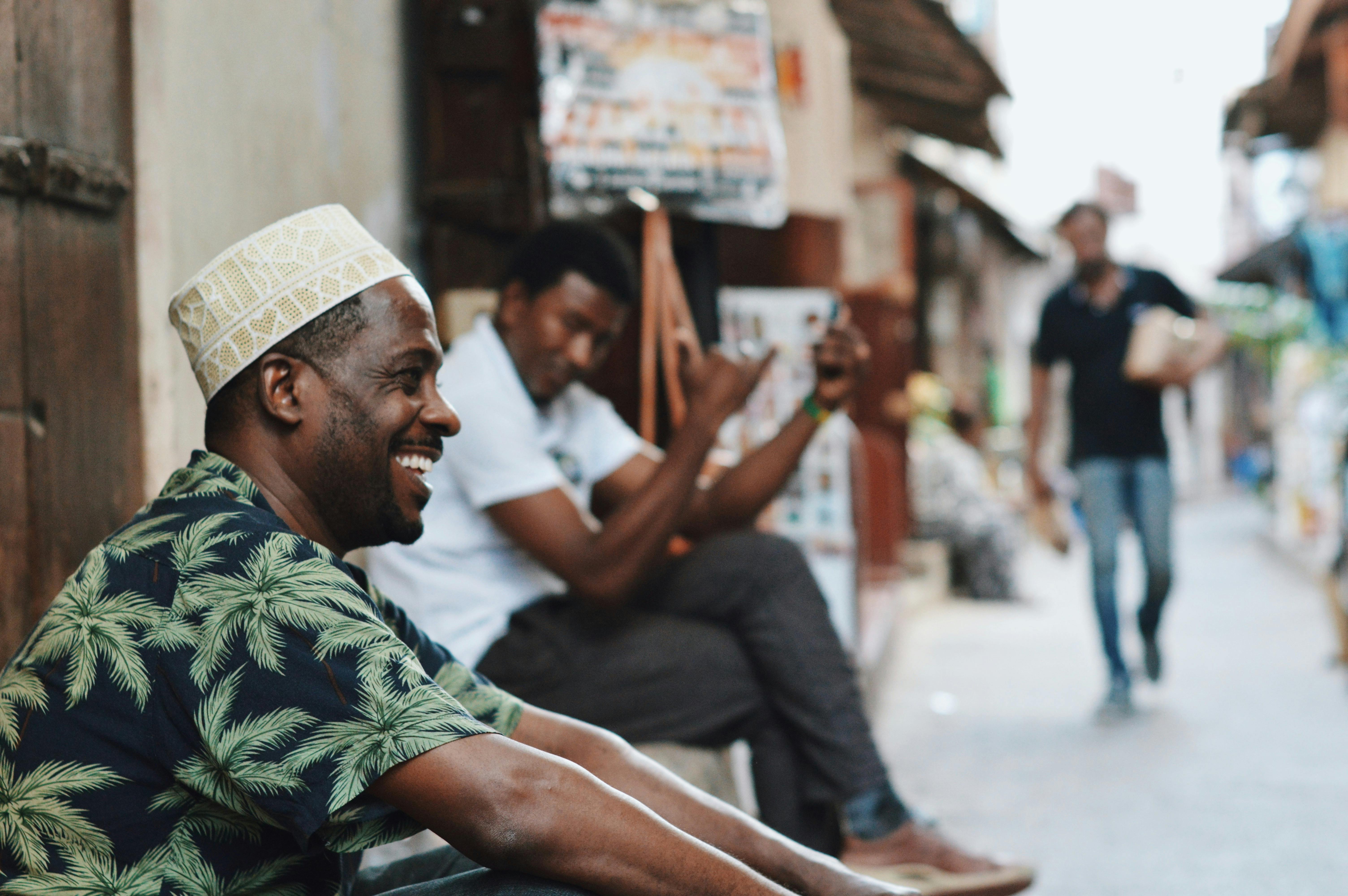 Casual street scene in Zanzibar City with men enjoying the day. Capturing vibrant street life and cu