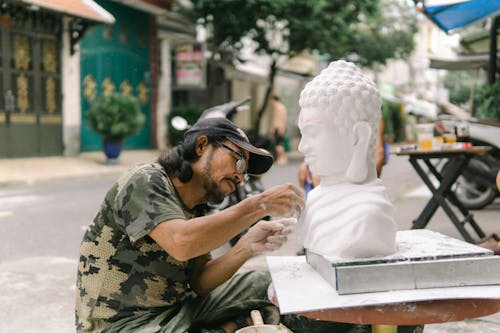 Man sculping the statue of Buddha