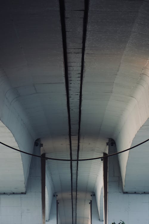 A man is standing in the middle of a tunnel