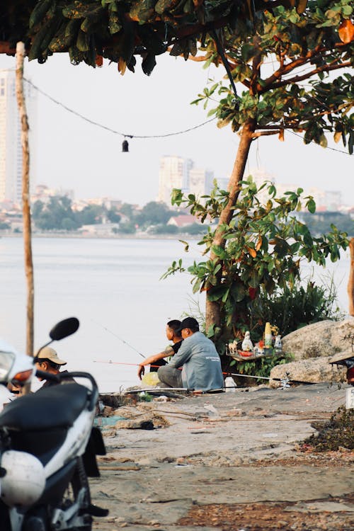 A man sitting on a bench next to a motorcycle