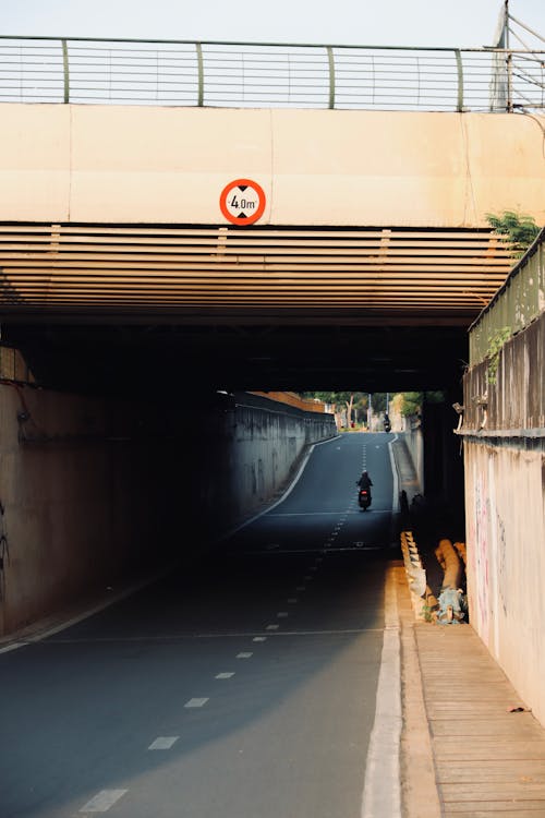 A person riding a bike through a tunnel