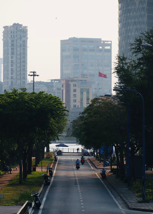 A city street with a motorcycle and a car