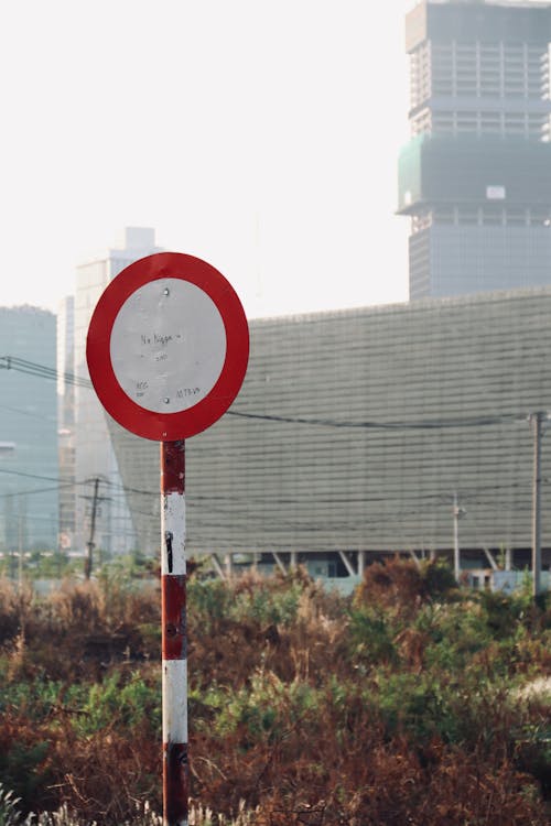 A red and white stop sign in front of a building