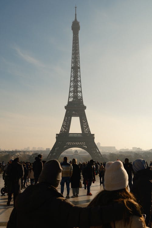 Free People are standing in front of the eiffel tower Stock Photo