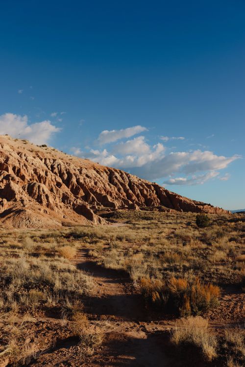 Free Explore the arid terrain and striking rock formations of Caliente, Nevada under clear blue skies. Stock Photo