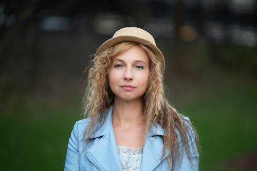 A woman in a blue jacket and hat