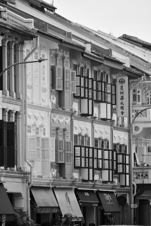 A black and white photo of a street with buildings