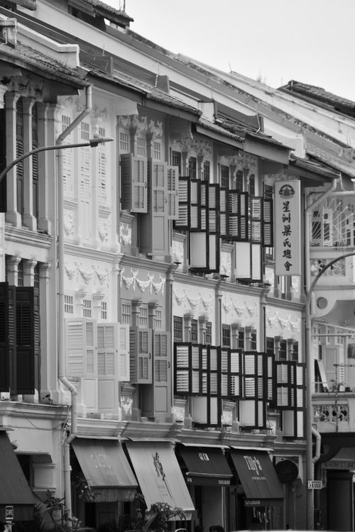 Free Black and white photo of traditional shophouses in Chinatown, Singapore showcasing colonial architecture. Stock Photo