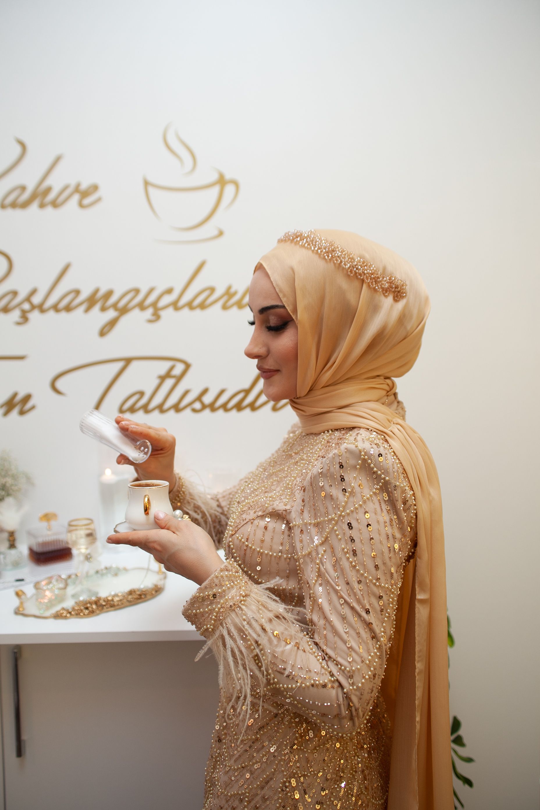 Smiling Bride in Dress and Hijab Standing by Table with Flowers  Free  Stock Photo