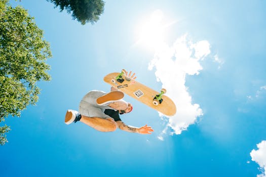 Skateboarder executing a dynamic mid-air stunt against a bright summer sky.