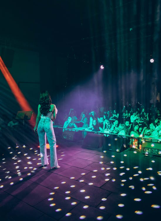 A woman standing on stage in front of a crowd