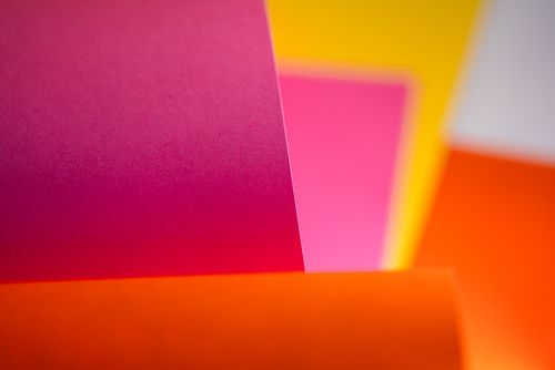 Free Colorful abstract image of pink, orange, and yellow paper sheets with soft focus. Stock Photo