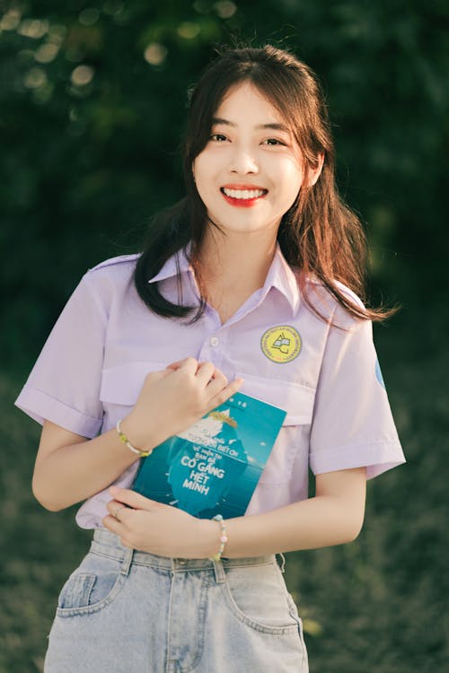 Free Smiling Brunette with Book Stock Photo