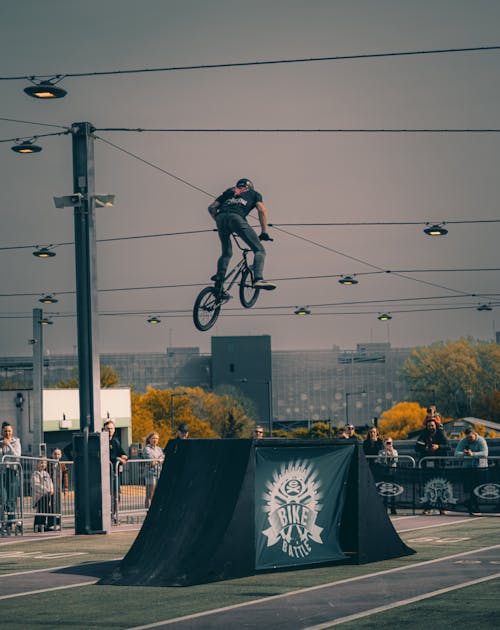 A person on a bike jumping over a ramp