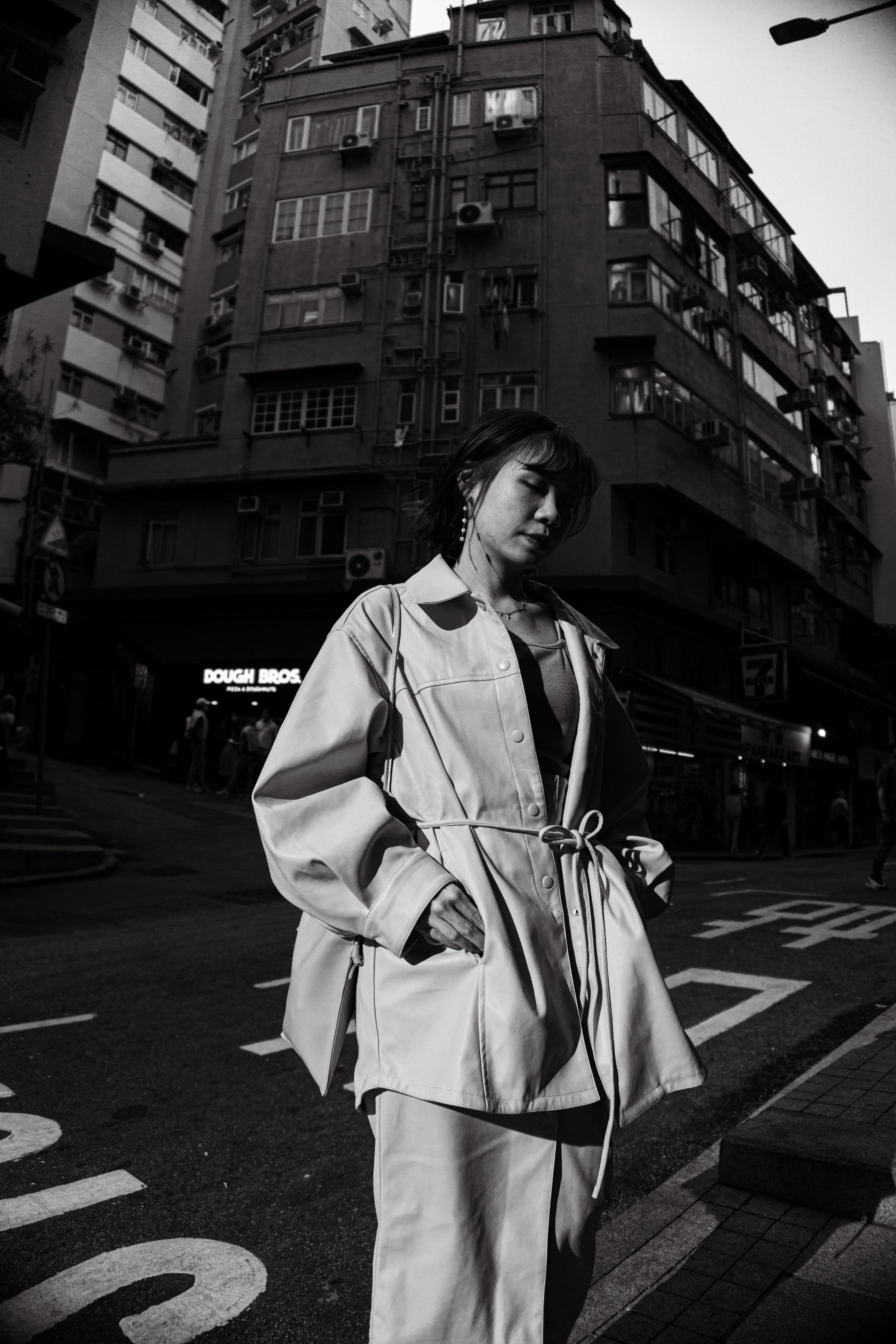 A Fashionable Woman Standing on a Street in a City · Free Stock Photo