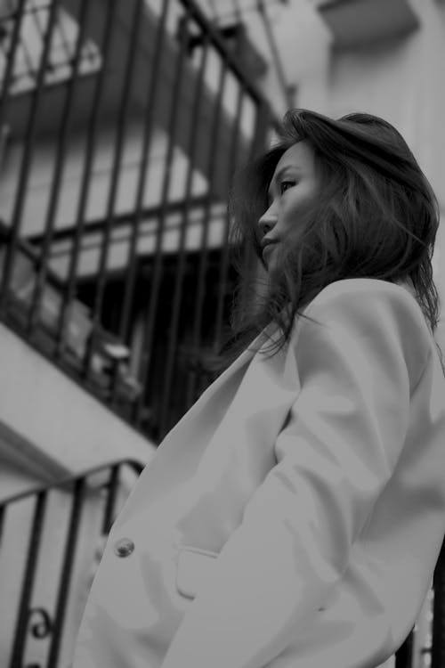 Free A woman in a white blazer and hat Stock Photo