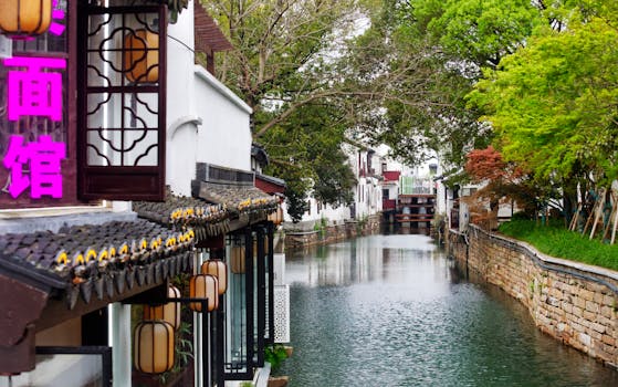 Serene canal view in Suzhou's historic water town Zhouzhuang, showcasing traditional architecture.