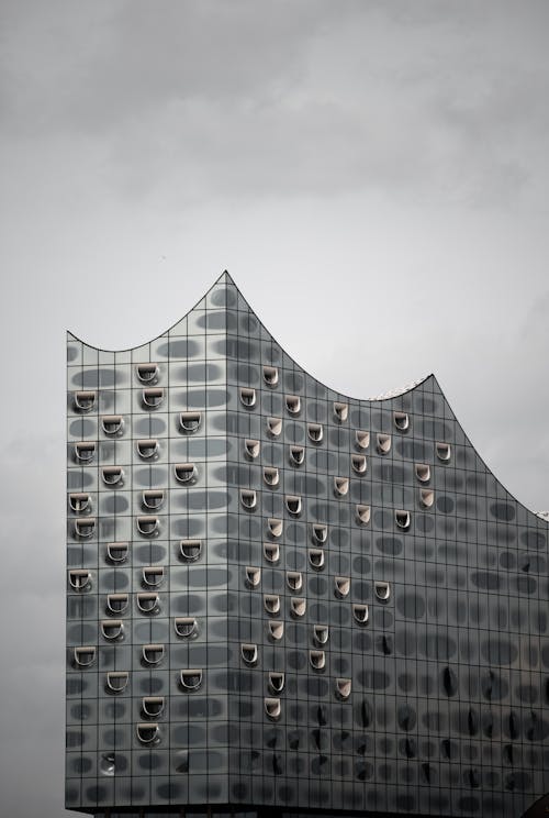 A building with many windows and a cloudy sky