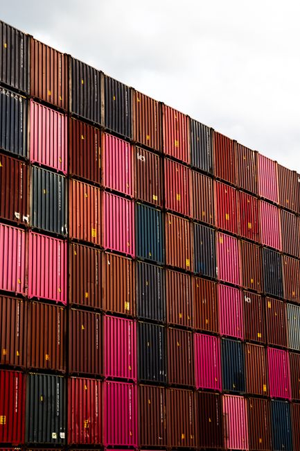 Stacked cargo containers in vibrant colors at Hamburg port.