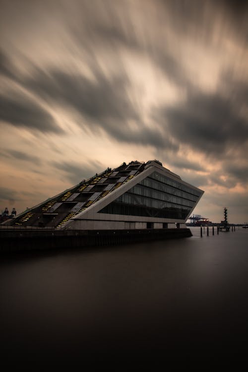 A long exposure photograph of a building on the water